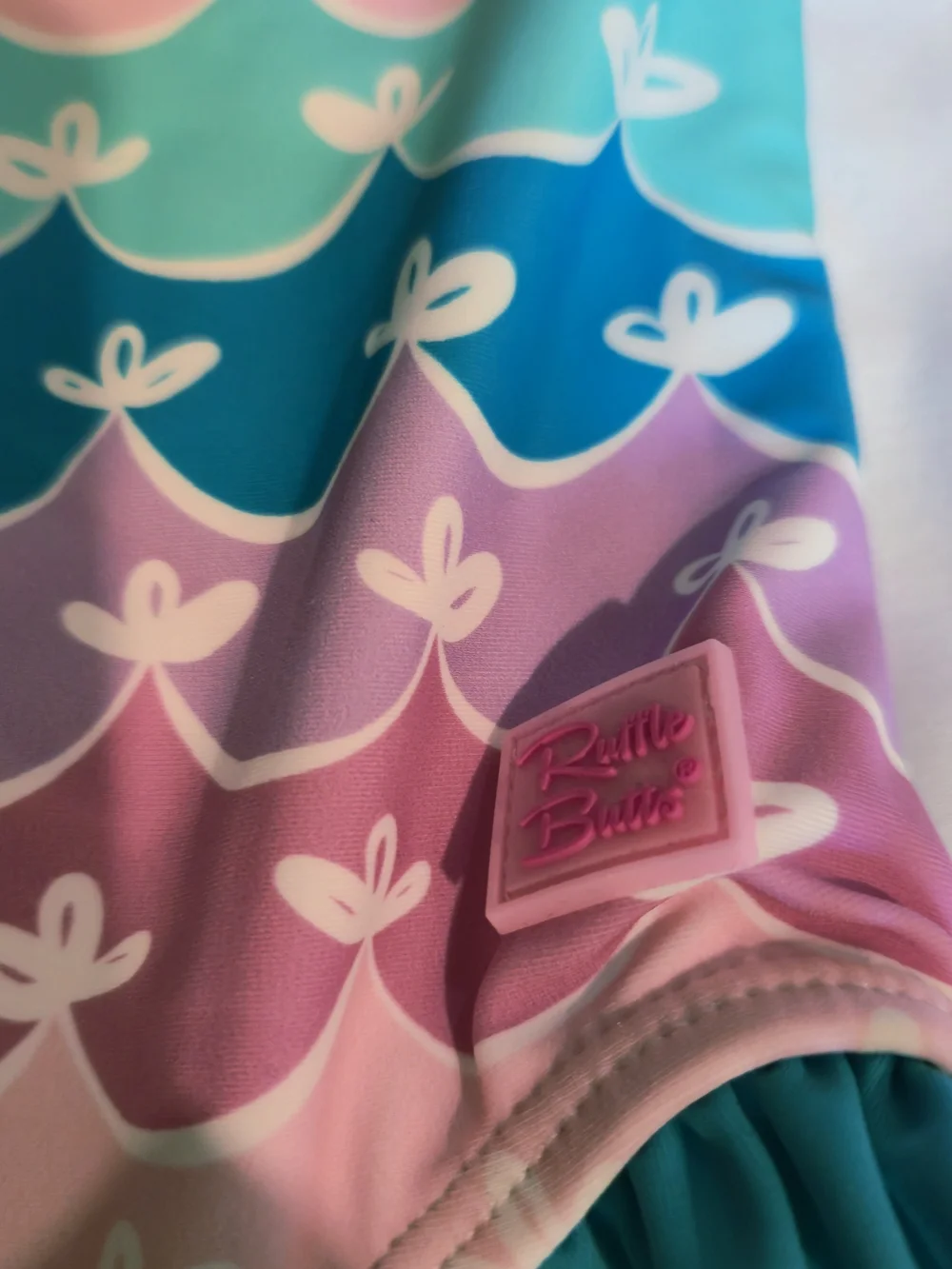 Rufflebutts Pastel Wave One-Shoulder Swimsuit in Teal, Lavender, Pink